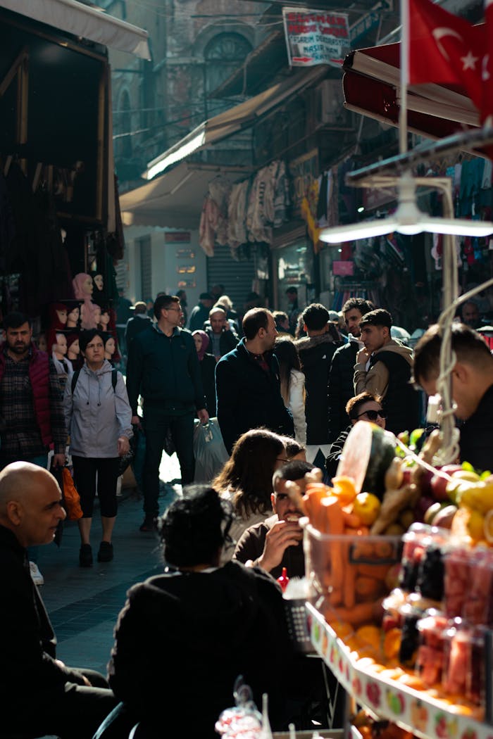 Services Colorful street market bustling with people and fresh produce under daylight.