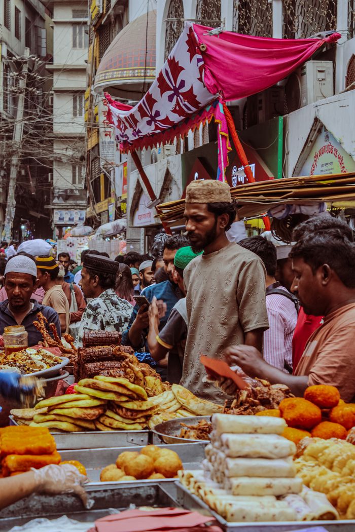 Crowded street market showcasing various traditional and colorful foods, highlighting local culture.